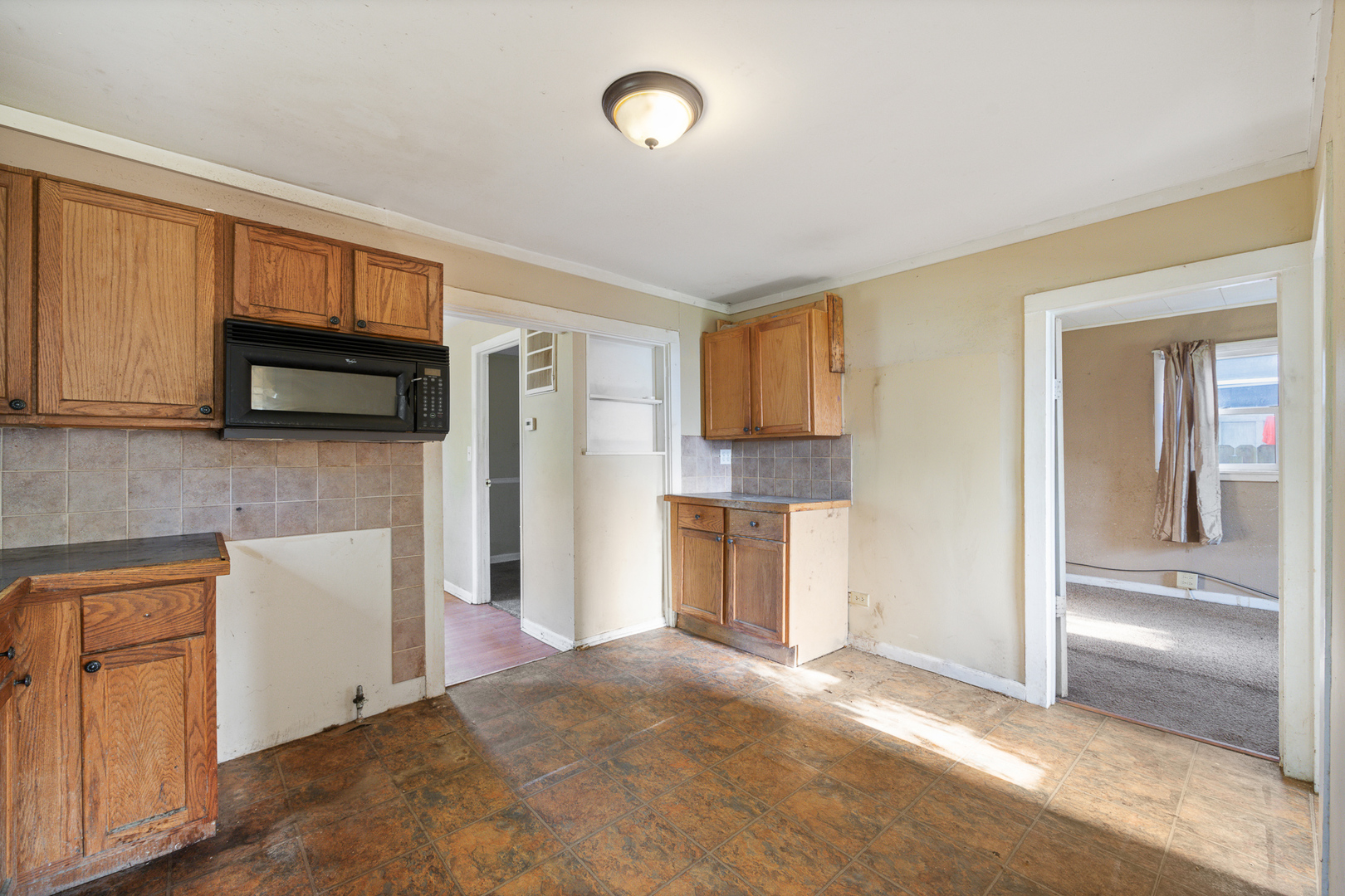 208 South Park Road Joliet, IL 60433 - Photo 14 of 29 a view of a kitchen with refrigerator and microwave