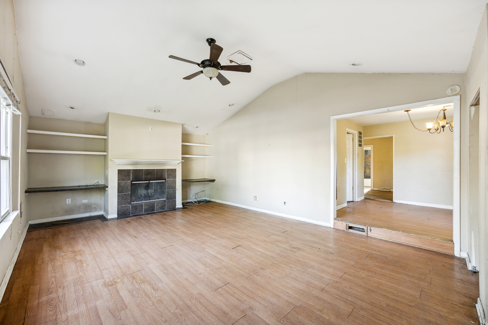 208 South Park Road Joliet, IL 60433 - Photo 9 of 29 a view of empty room with wooden floor and fireplace