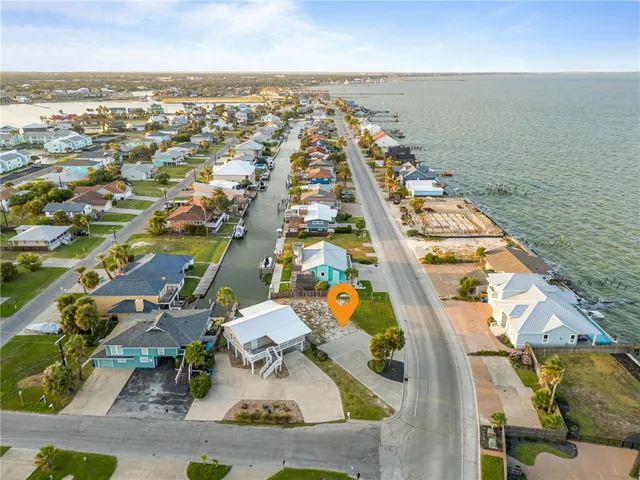 an aerial view of residential houses with outdoor space