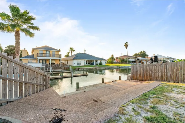 a view of a lake with couches and wooden floor