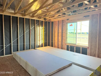 a large bed sitting in a bedroom next to a window