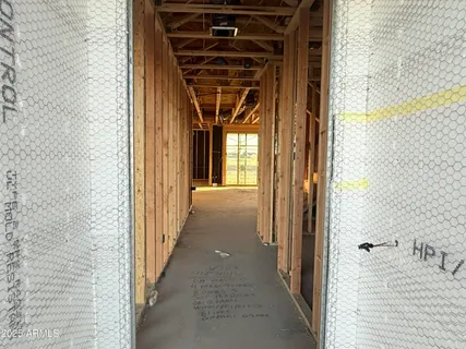 a view of a hallway with wooden walls and a window