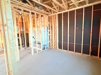 a view of empty room with wooden floor and door