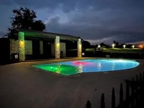 a view of a house with swimming pool and a yard