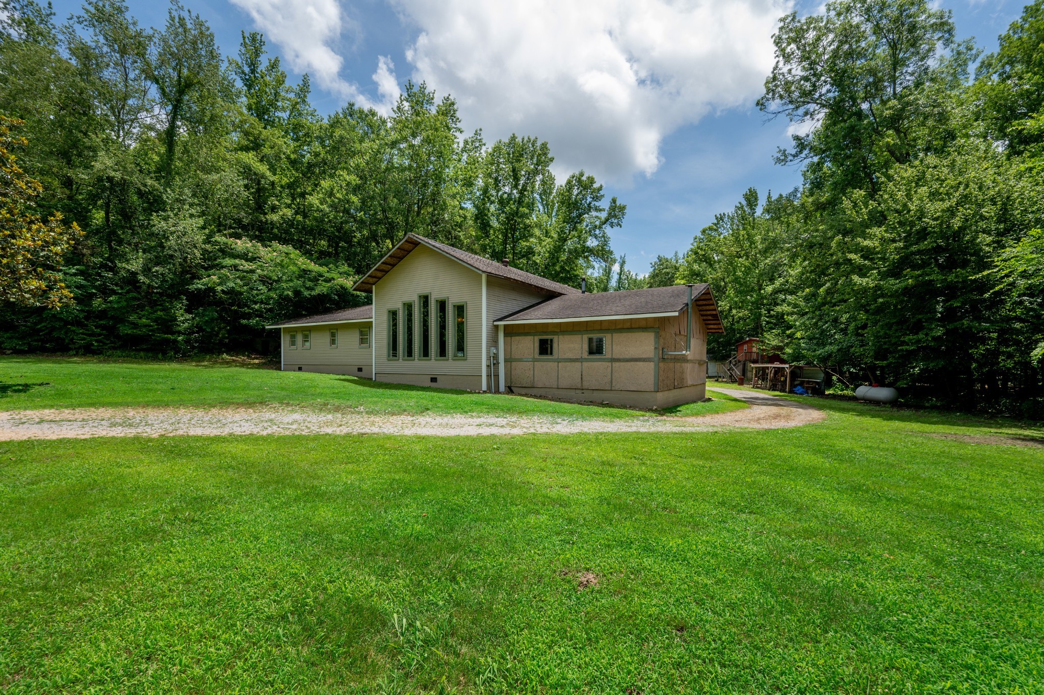 a front view of house with yard and green space