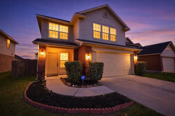 a view of a house with potted plants in front of house