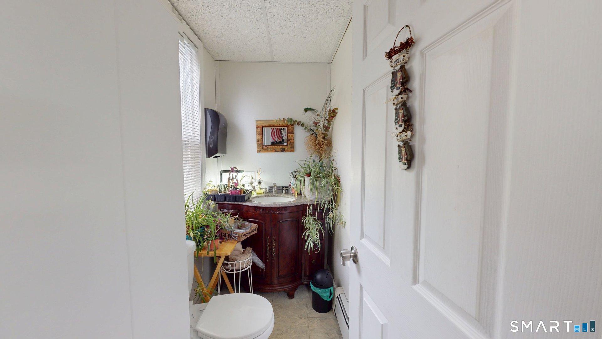138 Main Street Somers, CT 06071 - Photo 11 of 38 a bathroom with a sink toilet and mirror