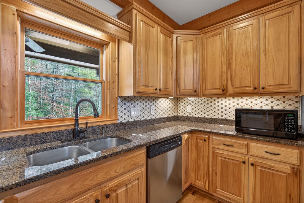496 John Crow Road Dahlonega, GA 30533 - Photo 12 of 74 a kitchen with stainless steel appliances granite countertop a sink a stove and cabinets