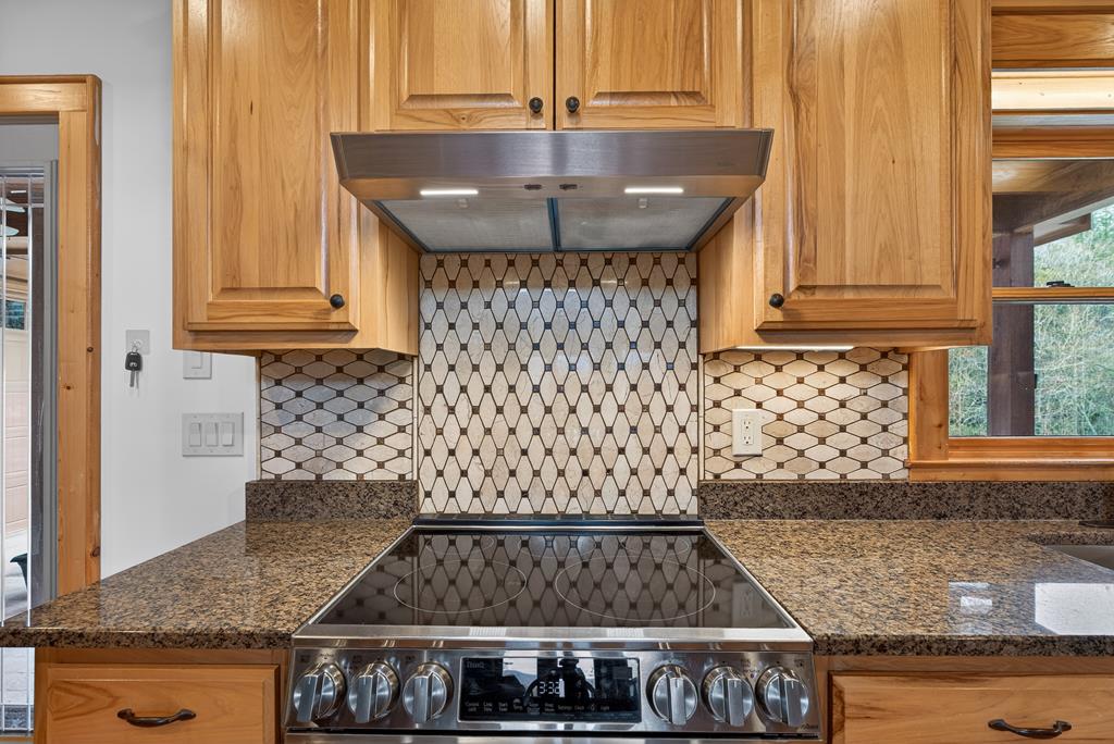 496 John Crow Road Dahlonega, GA 30533 - Photo 13 of 74 a kitchen with granite countertop a stove and a sink