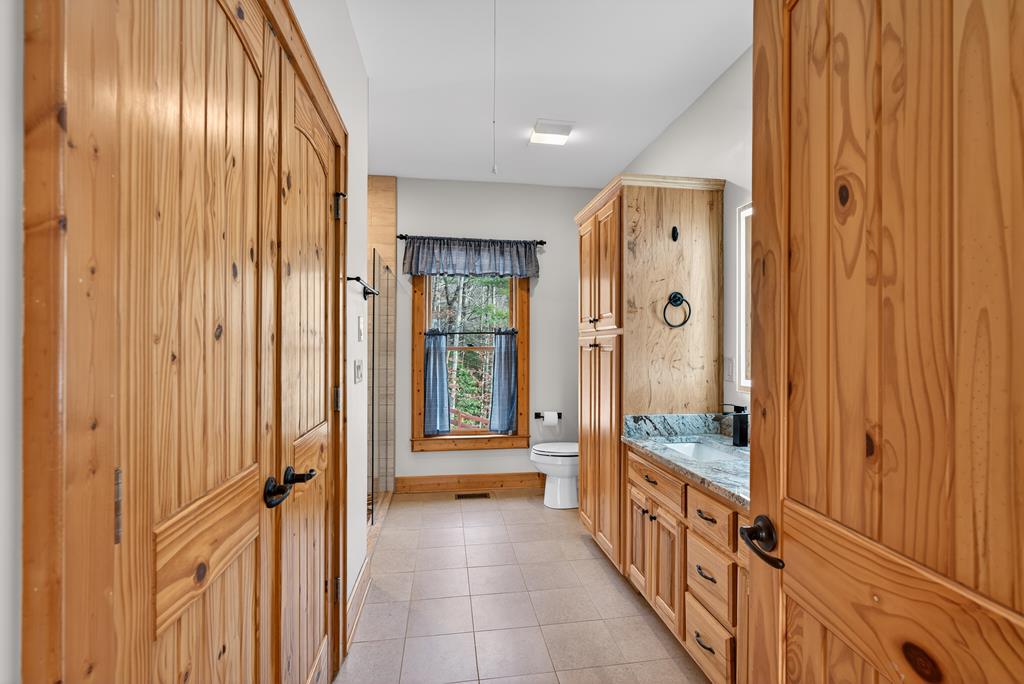 496 John Crow Road Dahlonega, GA 30533 - Photo 18 of 74 a spacious en suite bathroom with a sink and a mirror