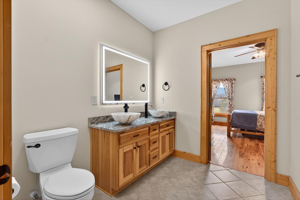 496 John Crow Road Dahlonega, GA 30533 - Photo 22 of 74 a spacious bathroom with a toilet a sink and a mirror