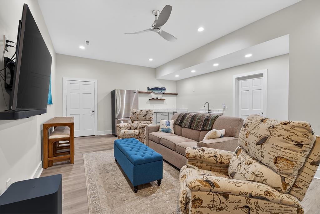 496 John Crow Road Dahlonega, GA 30533 - Photo 34 of 74 a living room with furniture a flat screen tv and kitchen view