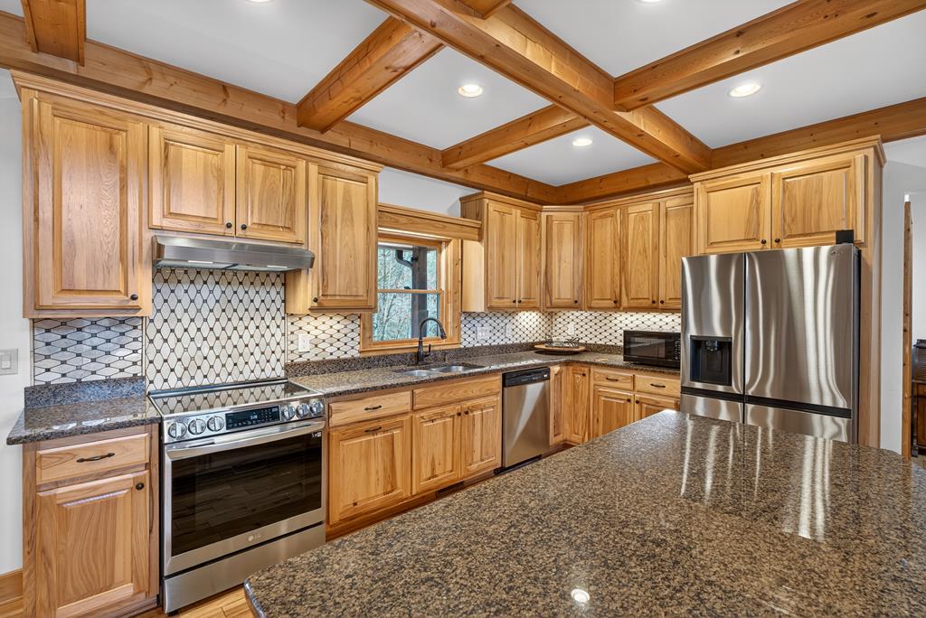 496 John Crow Road Dahlonega, GA 30533 - Photo 54 of 74 a kitchen with stainless steel appliances granite countertop a stove sink refrigerator and cabinets