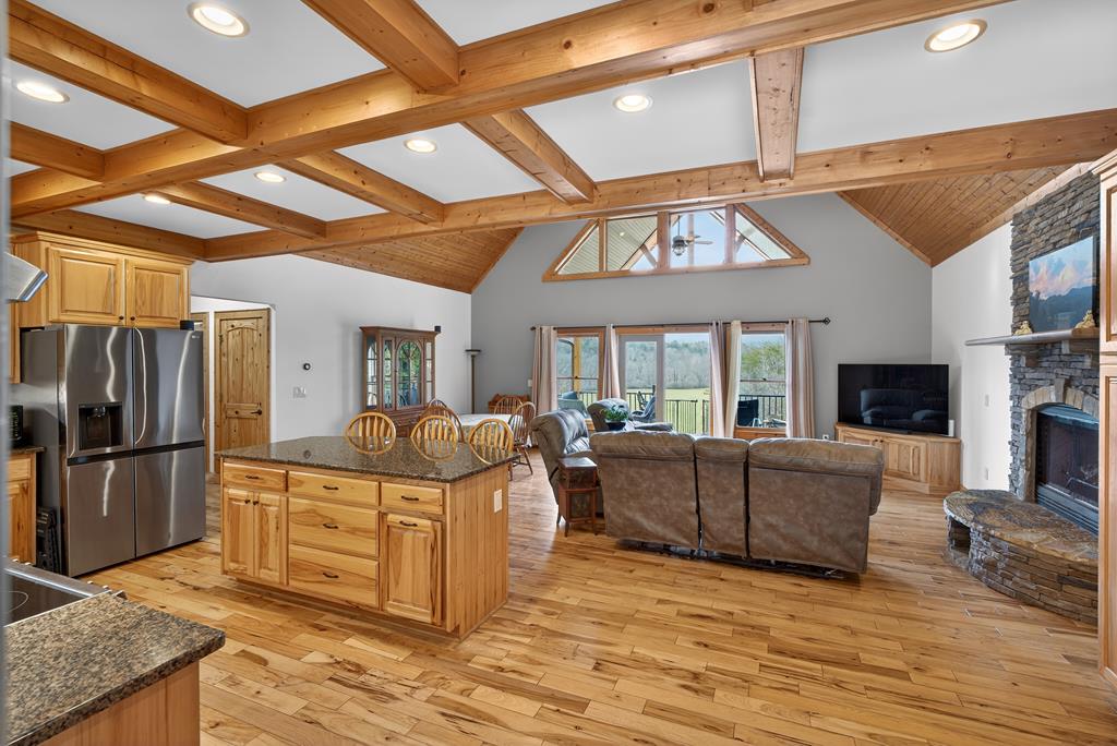 496 John Crow Road Dahlonega, GA 30533 - Photo 55 of 74 a living room with furniture a flat screen tv and kitchen view