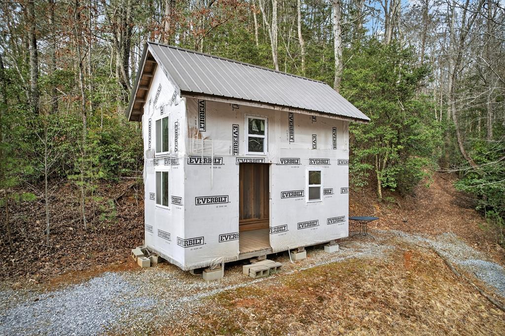 496 John Crow Road Dahlonega, GA 30533 - Photo 74 of 74 a view of a white house with large trees and outdoor space
