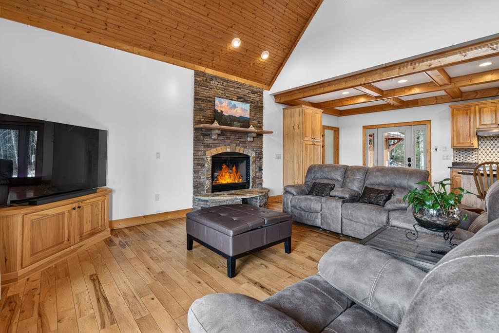496 John Crow Road Dahlonega, GA 30533 - Photo 10 of 74 a living room with furniture a flat screen tv and a fireplace