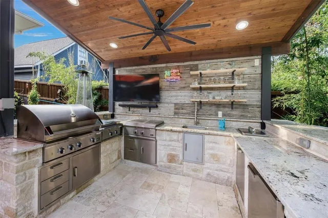 a kitchen with stainless steel appliances granite countertop a sink and a stove