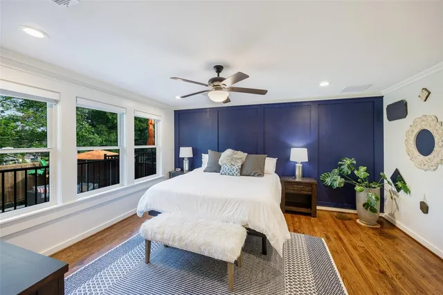 a bed room with a bed and a large window