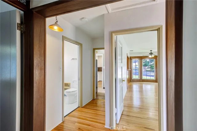 a view of a hallway with wooden floor and staircase