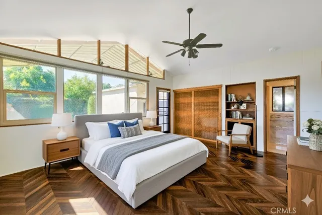 a bedroom with a large bed and a large window