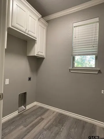 a view of a kitchen with wooden cabinet and a window