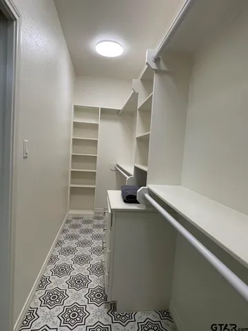 a room with walk in closet and a window