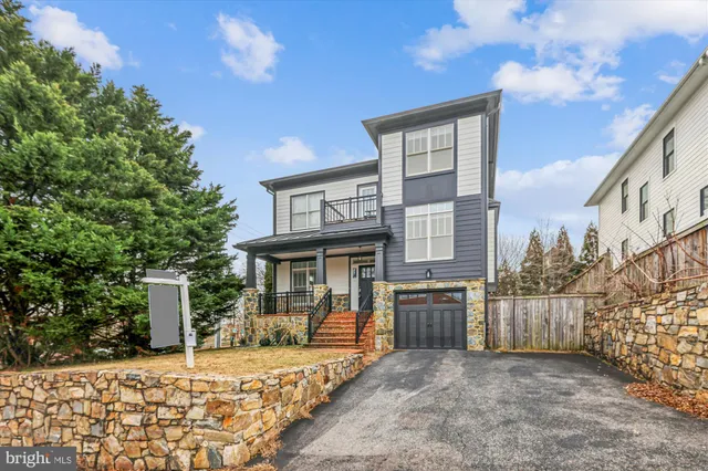 front view of a house with a large tree
