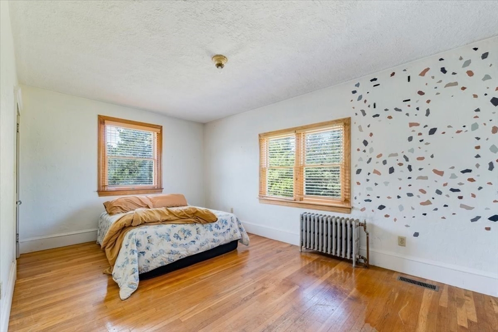 70 Hedge Road Plymouth, MA 02360 - Photo 23 of 41 a bedroom with a bed and wooden floor