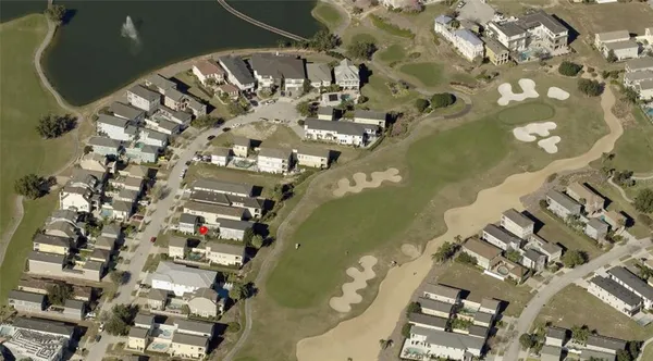 an aerial view of a multi story residential apartment building with yard