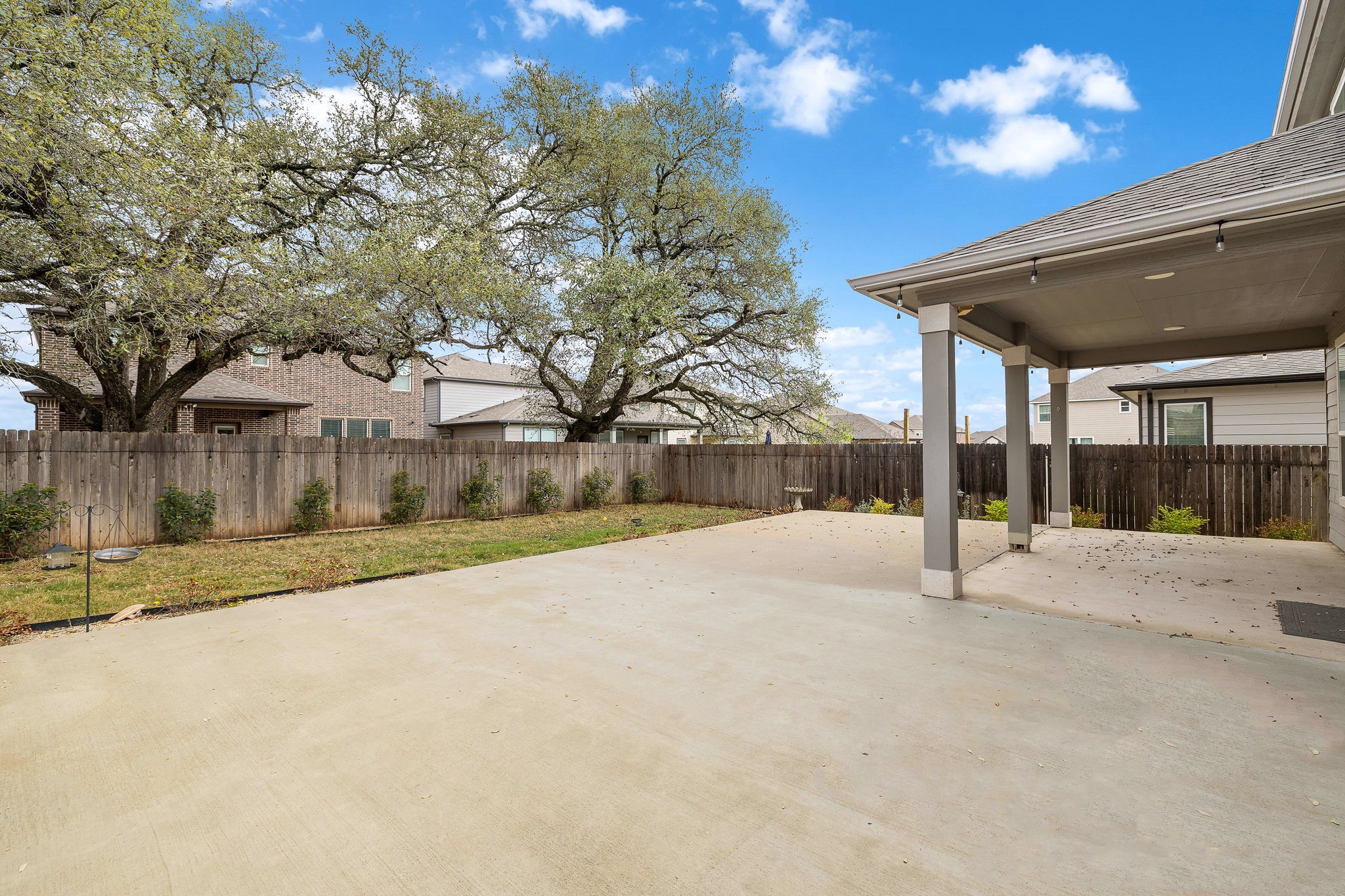 717 Priscilla Court Leander, TX 78641 - Photo 33 of 37 Outdoor retreat with expanded patio and beautiful green views of the mature trees