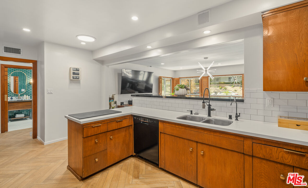 1534 Belleau Road Glendale, CA 91206 - Photo 16 of 40 a kitchen with a sink and wooden cabinets