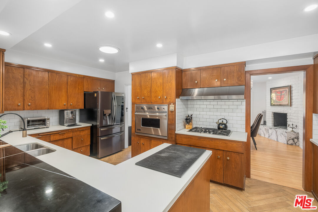 1534 Belleau Road Glendale, CA 91206 - Photo 18 of 40 a kitchen with stainless steel appliances granite countertop a sink a stove and a refrigerator