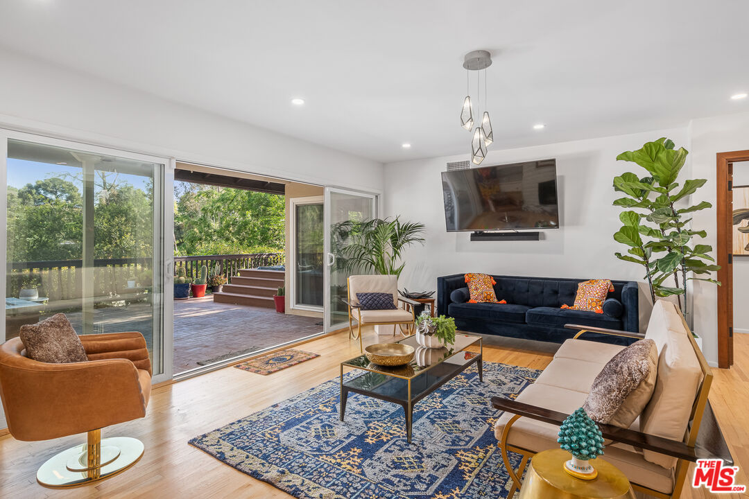 1534 Belleau Road Glendale, CA 91206 - Photo 19 of 40 a living room with furniture a flat screen tv and a large window