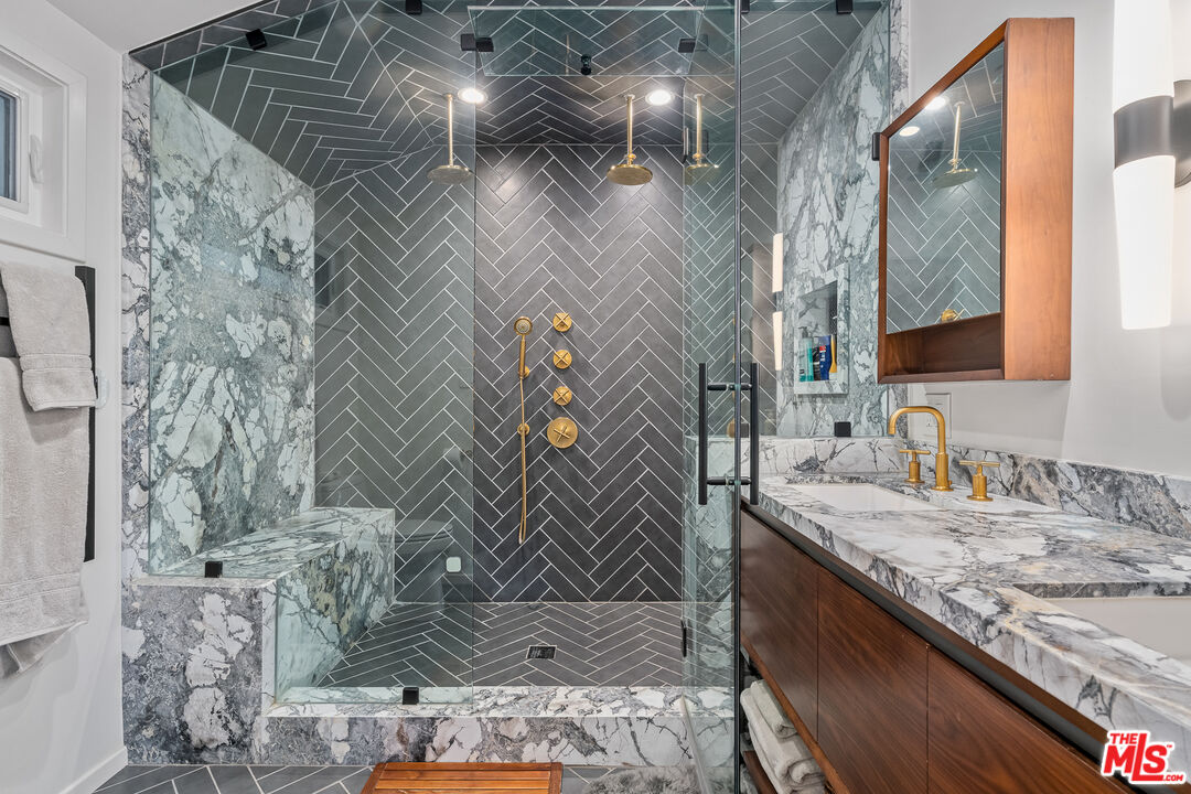 1534 Belleau Road Glendale, CA 91206 - Photo 27 of 40 a bathroom with a granite countertop sink a mirror and shower