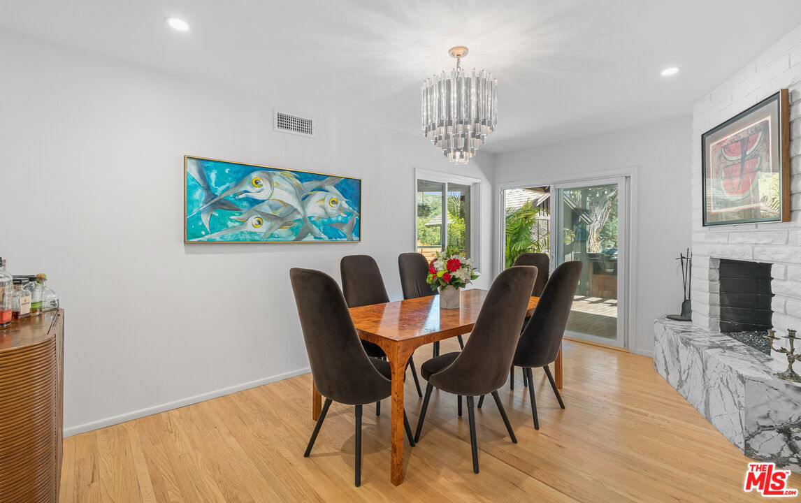 1534 Belleau Road Glendale, CA 91206 - Photo 8 of 40 a view of a dining room with furniture a chandelier and wooden floor