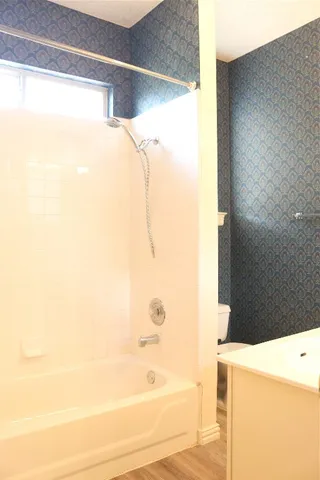 a bathroom with a bathtub and shower