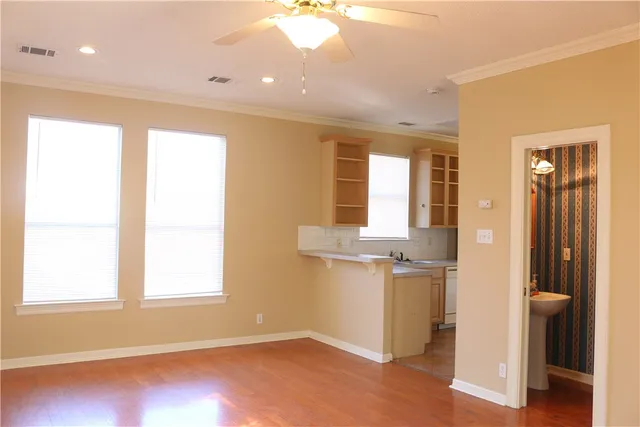 an empty room with windows and entrance