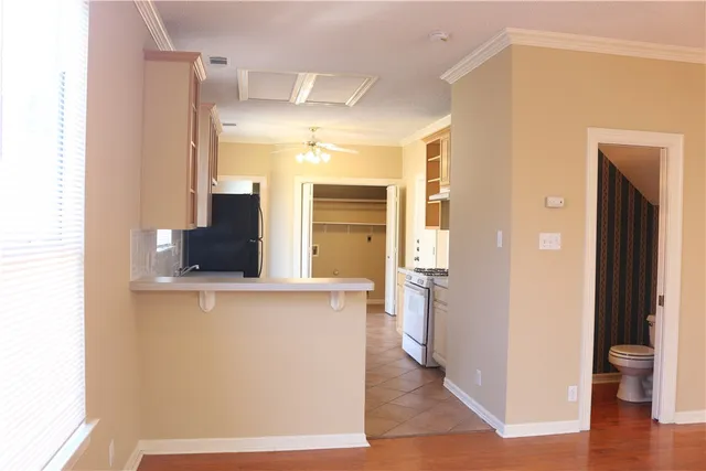 a view of a kitchen cabinets and wooden floor