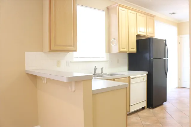 a kitchen with appliances cabinets and a sink