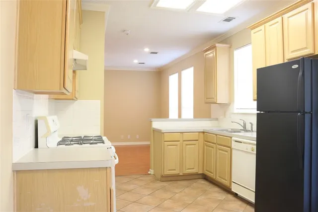 a kitchen with a sink stove and refrigerator