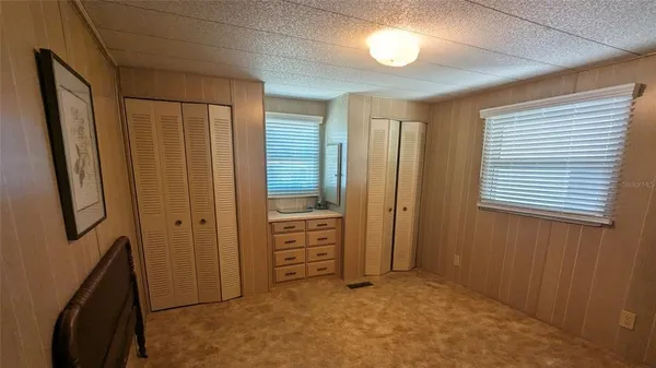 an empty room with windows and closet