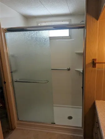 a bathroom with a glass shower door