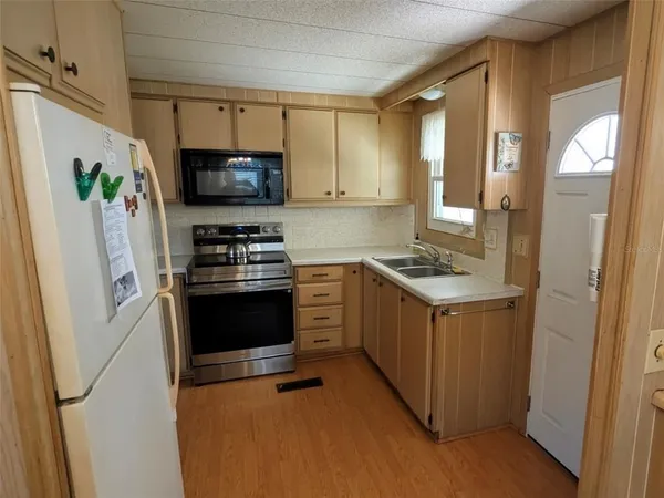 a kitchen with a refrigerator stove and microwave
