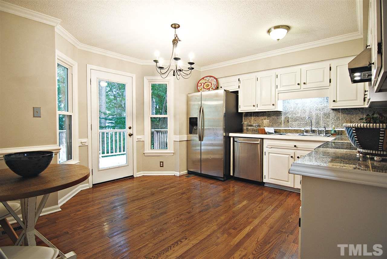 1716 Park Ridge Way Raleigh, NC 27614 - Photo 6 of 24 a kitchen with stainless steel appliances a stove top oven a sink dishwasher a refrigerator white cabinets and wooden floor