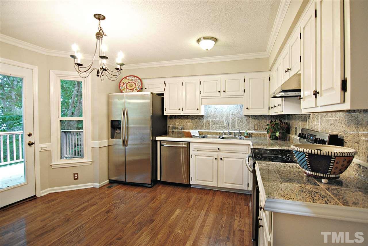 1716 Park Ridge Way Raleigh, NC 27614 - Photo 7 of 24 a kitchen with stainless steel appliances granite countertop a stove a sink dishwasher and a refrigerator with wooden floor