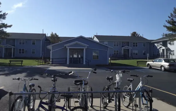 a view of house with backyard and sitting area