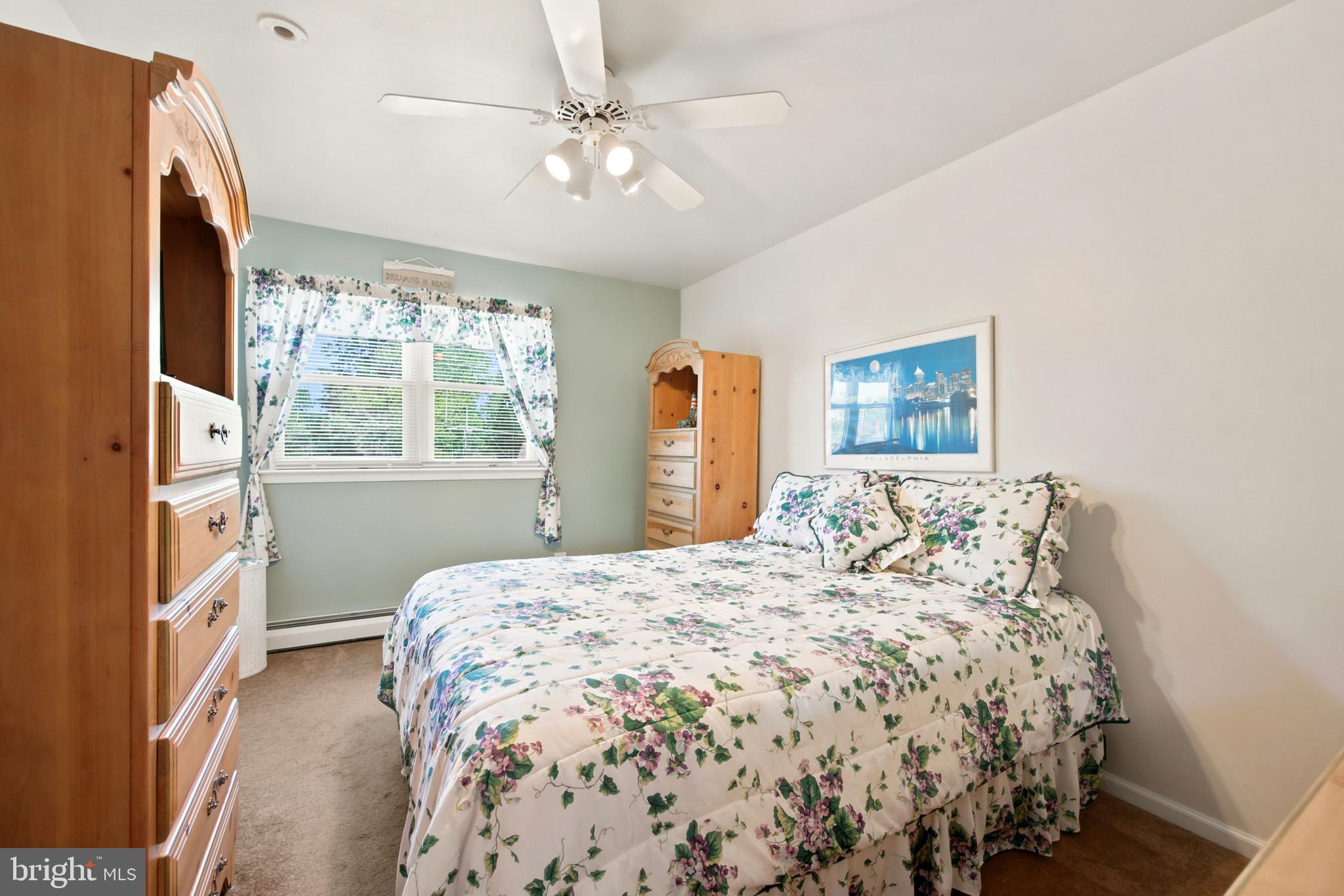 1004 Green Lane Secane, PA 19018 - Photo 25 of 49 a bedroom with a large bed and a chandelier