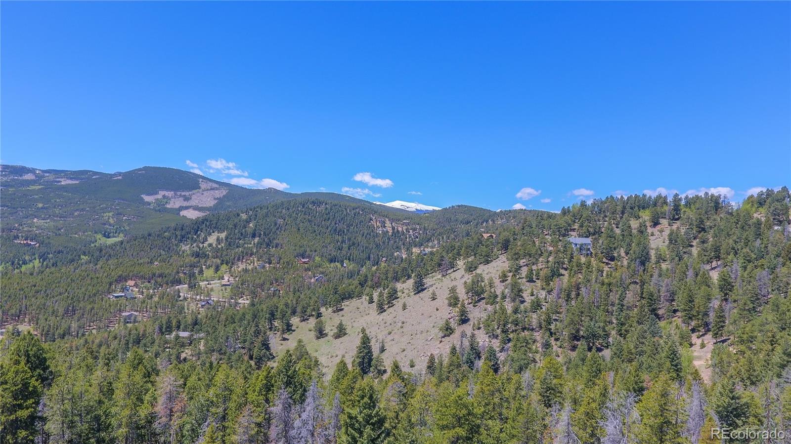 7291 Timber Trail Road Evergreen, CO 80439 - Photo 7 of 7 a view of a city with a mountain in the background