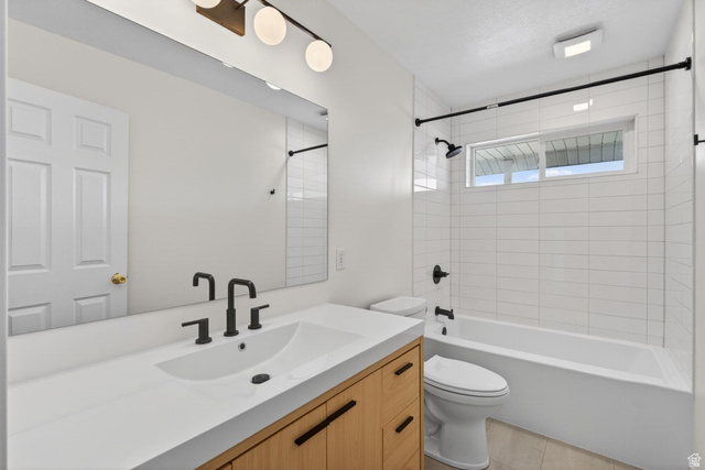 380 Luzern Road Midway, UT 84049 - Photo 29 of 74 Bathroom featuring a wood-finish vanity with a white countertop and integrated sink, matte black fixtures, and a frameless mirror