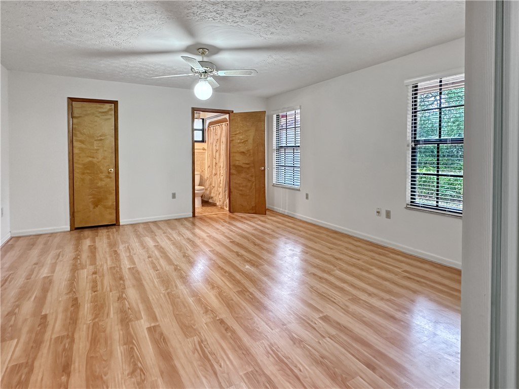 6602 Eden Road Fort Pierce, FL 34951 - Photo 14 of 24 a view of an empty room with wooden floor and a window